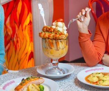 A Glass Of Wine And A Plate Of Food On A Table